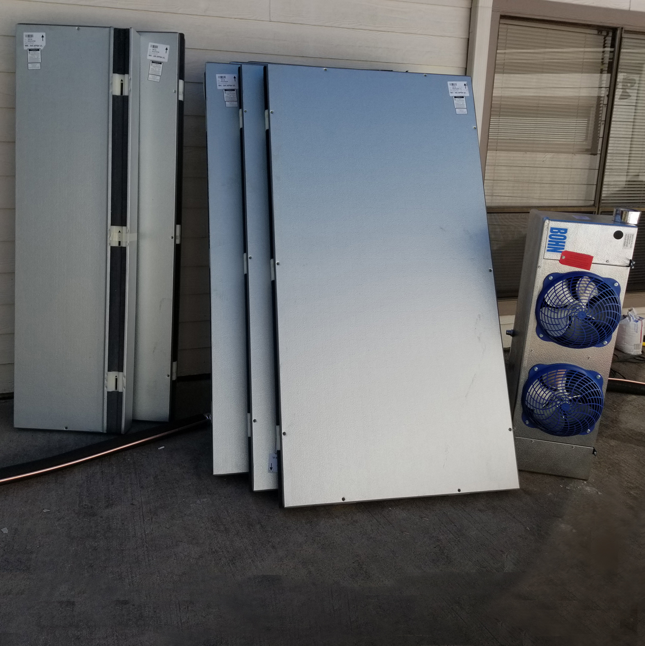 A group of large metal sheets and fans.