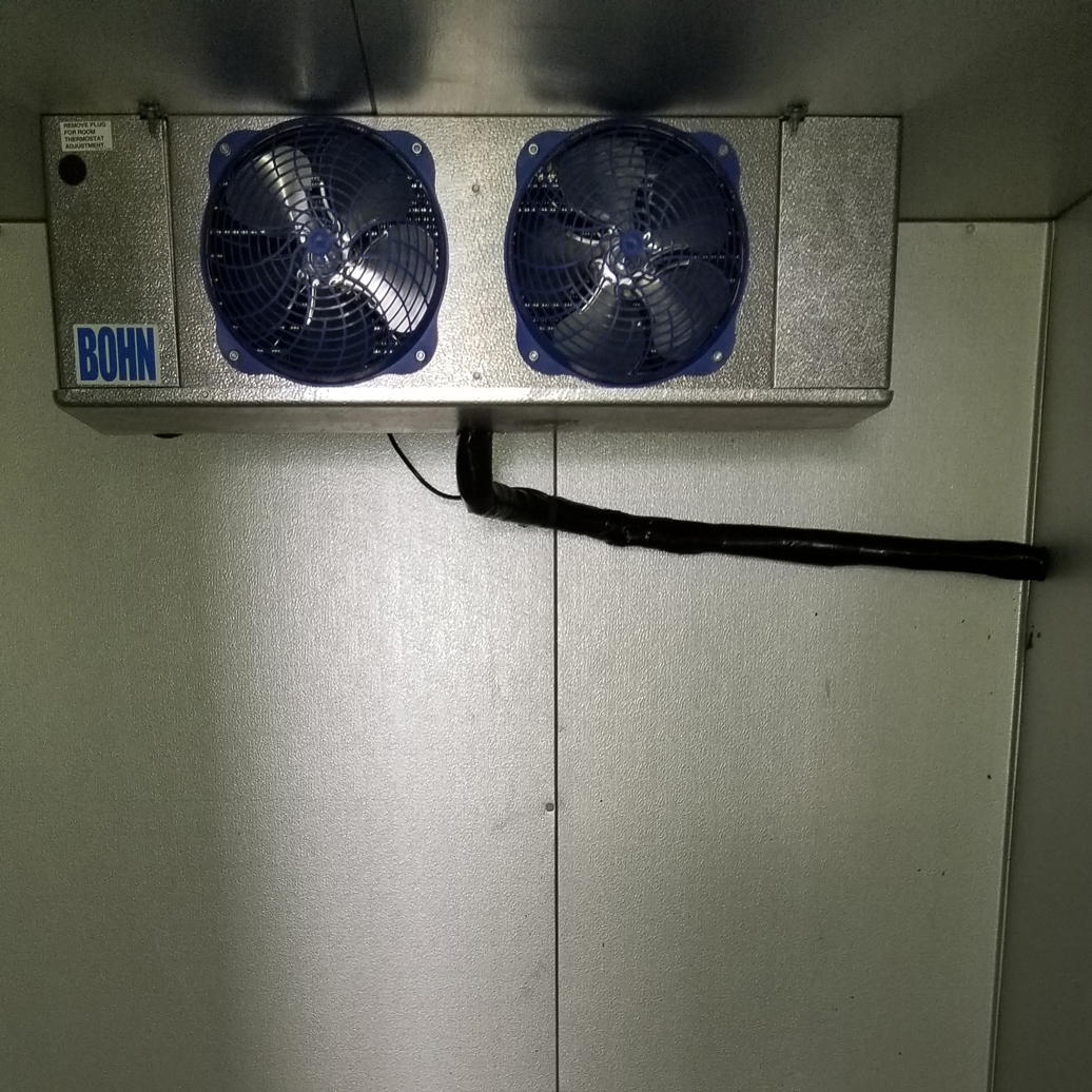 A room with two fans on the side of it.